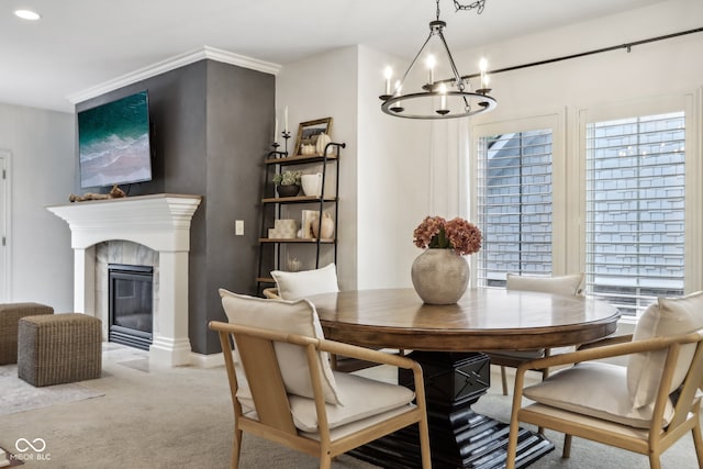 dining area featuring light carpet, an inviting chandelier, and a fireplace