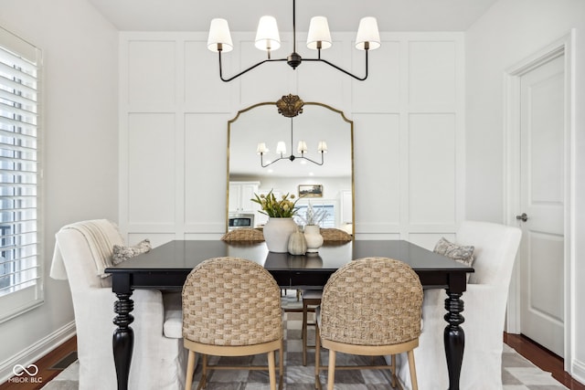 dining room with a notable chandelier and wood-type flooring