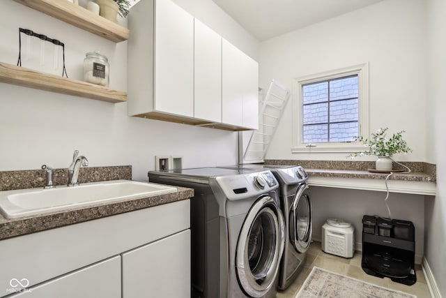 laundry room featuring sink, independent washer and dryer, light tile patterned floors, and cabinets