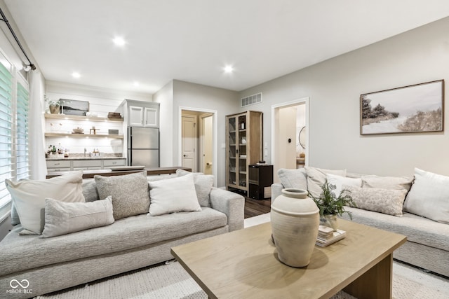 living room with sink and light hardwood / wood-style floors