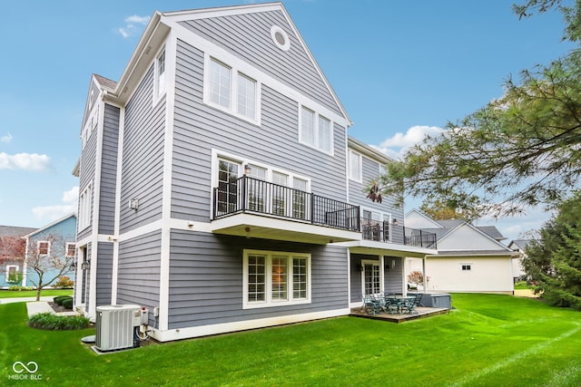 rear view of property with central air condition unit and a lawn