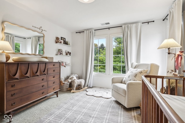 sitting room with carpet floors and plenty of natural light