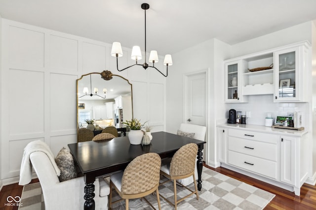 dining room with a chandelier and dark wood-type flooring