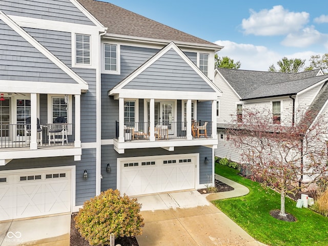 view of property featuring a balcony and a garage