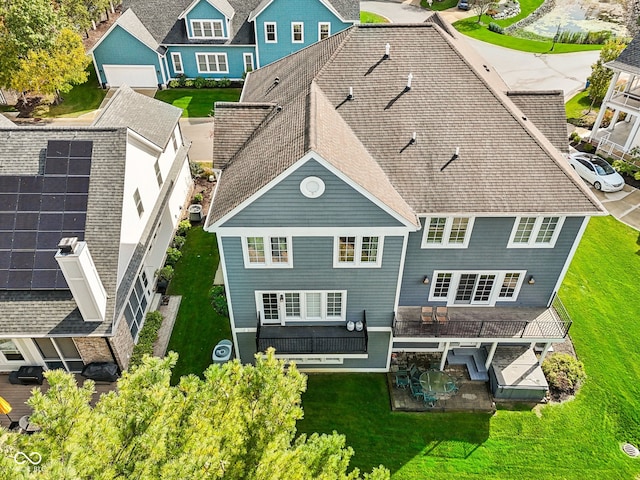 rear view of house with a yard and a garage