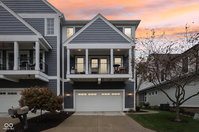 view of front of house featuring central AC unit, a garage, and a balcony