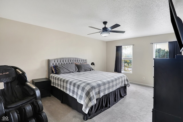 carpeted bedroom with a textured ceiling and ceiling fan