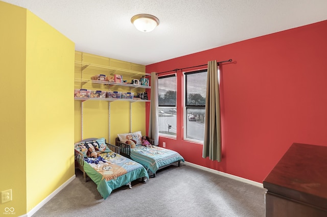 bedroom featuring a textured ceiling and carpet floors