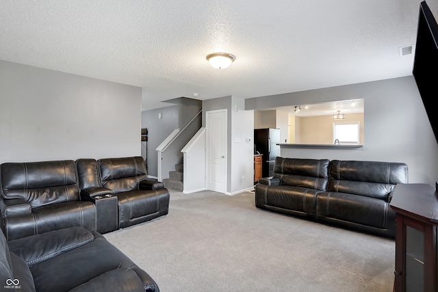 living room with carpet floors and a textured ceiling