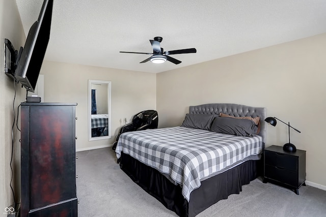 carpeted bedroom with a textured ceiling and ceiling fan