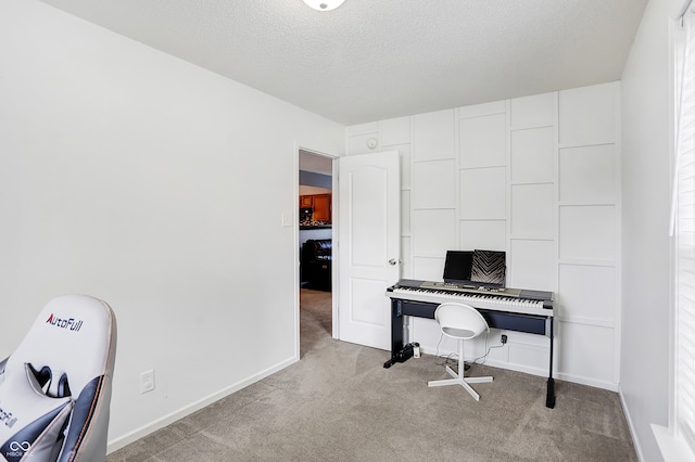 carpeted office space featuring a wealth of natural light and a textured ceiling