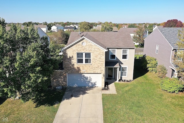 view of property with a front yard and a garage