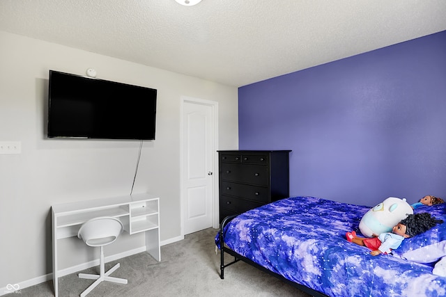 bedroom with a textured ceiling and carpet flooring