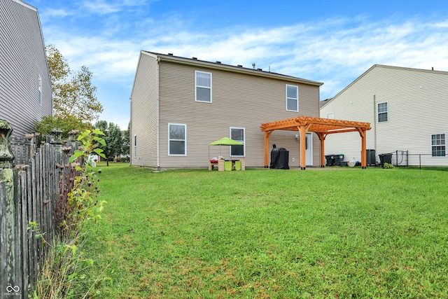 rear view of property with a lawn and a pergola