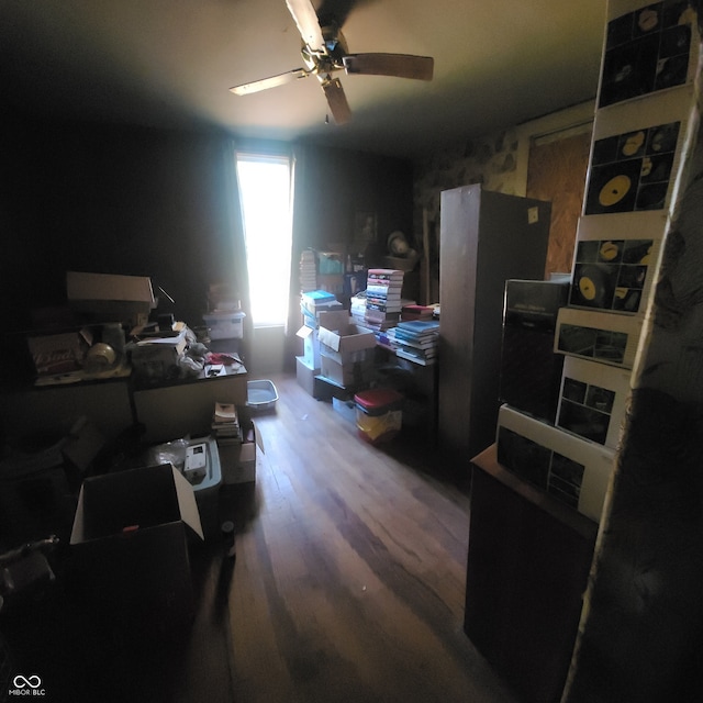 interior space with wood-type flooring and ceiling fan