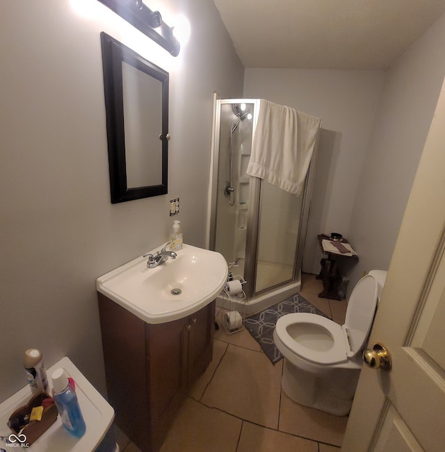 bathroom featuring vanity, tile patterned floors, toilet, and an enclosed shower