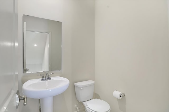 bathroom featuring sink and toilet