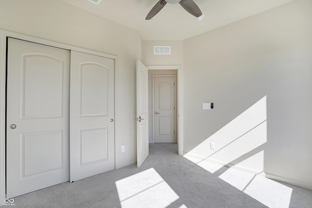 carpeted bedroom with a closet and ceiling fan