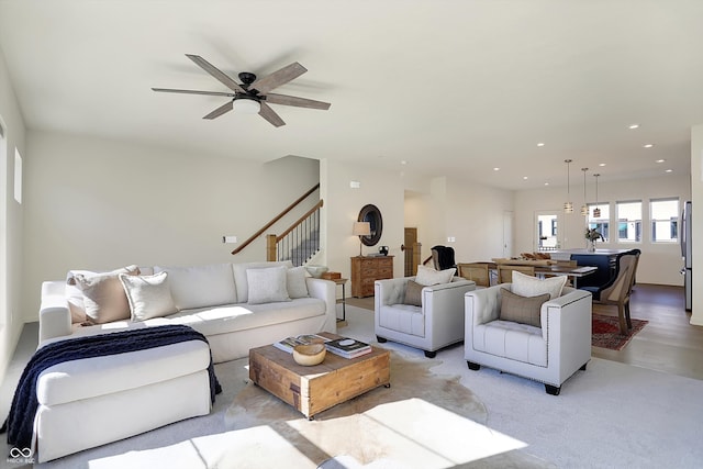 living room with light hardwood / wood-style flooring and ceiling fan