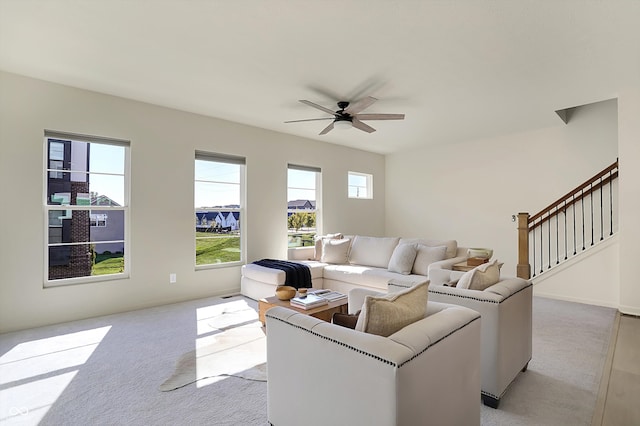 carpeted living room featuring ceiling fan