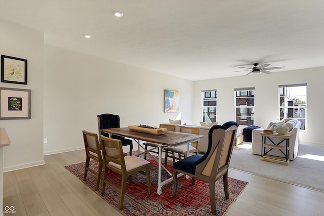 dining area with light hardwood / wood-style floors and ceiling fan