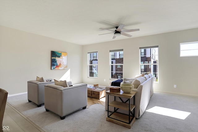 carpeted living room featuring ceiling fan