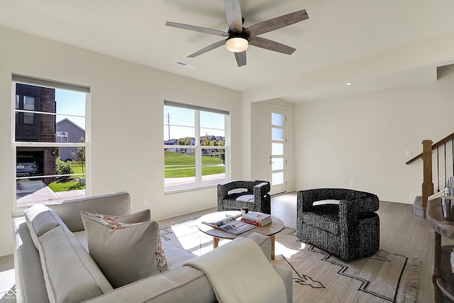 living room with light wood-type flooring and ceiling fan