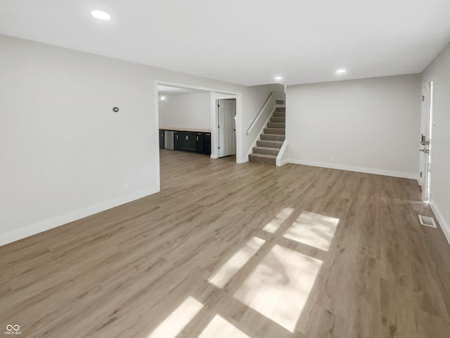 unfurnished living room featuring wood-type flooring