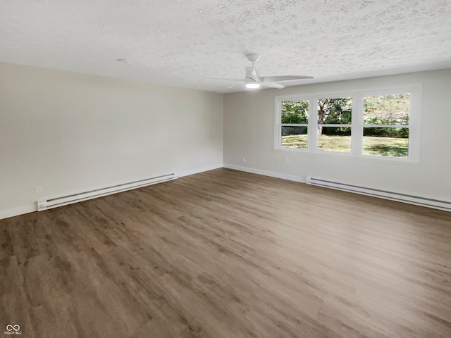 spare room with hardwood / wood-style floors, a baseboard heating unit, and a textured ceiling