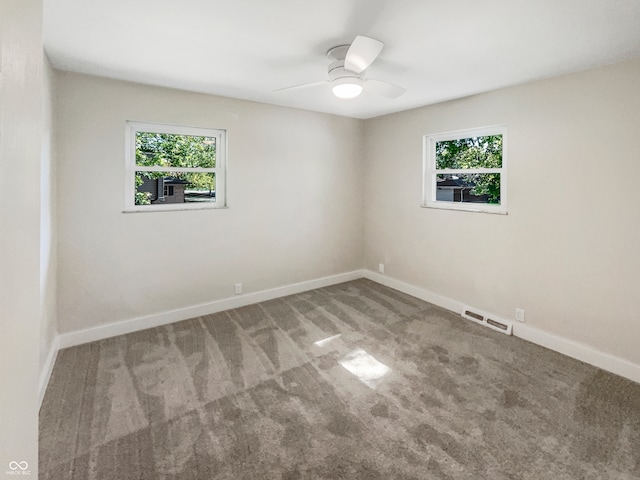 unfurnished room featuring carpet floors, a healthy amount of sunlight, and ceiling fan