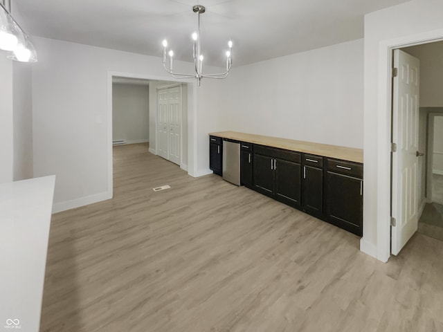 unfurnished dining area featuring light wood finished floors, a chandelier, baseboards, a baseboard heating unit, and visible vents