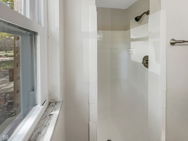 bathroom with tiled shower