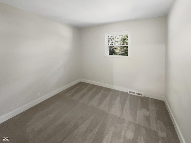carpeted spare room with baseboards and visible vents