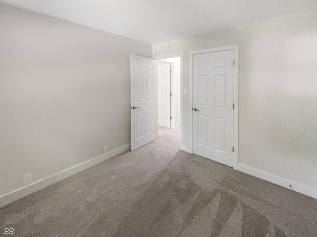 spare room with carpet flooring and baseboards