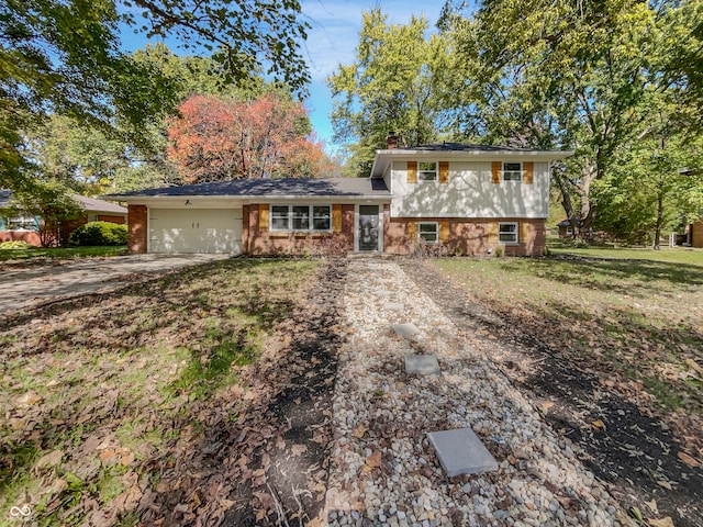 tri-level home featuring a front lawn and a garage