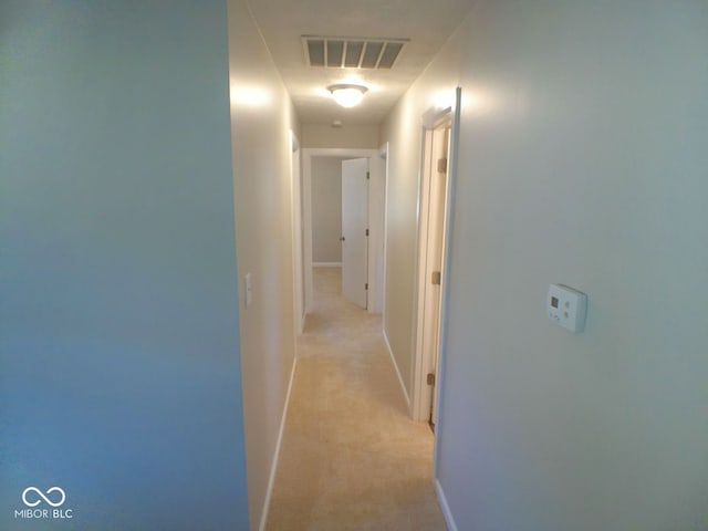 hallway with light colored carpet