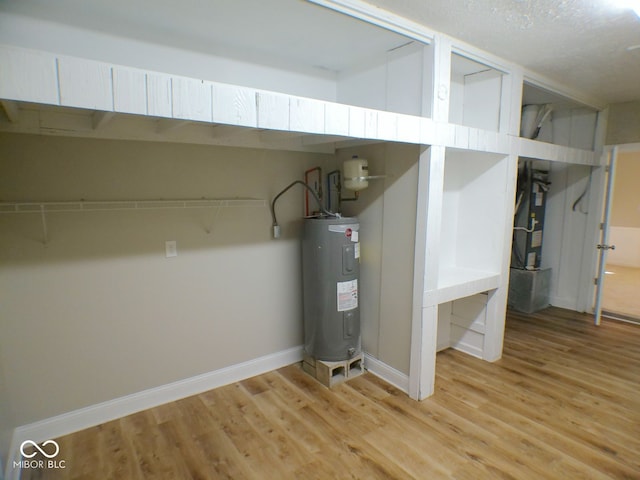 utility room featuring water heater