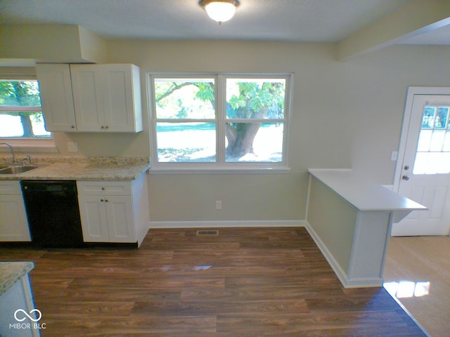 kitchen featuring dishwasher, dark hardwood / wood-style floors, kitchen peninsula, sink, and white cabinets