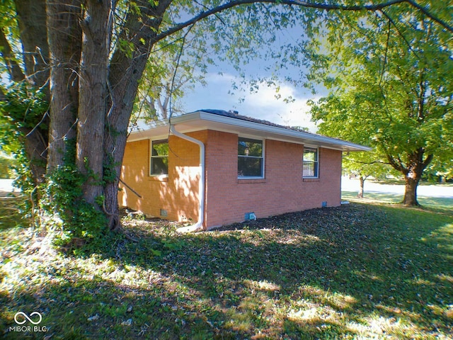 view of side of home featuring a lawn