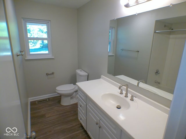 full bathroom with vanity, wood-type flooring, toilet, and bathing tub / shower combination