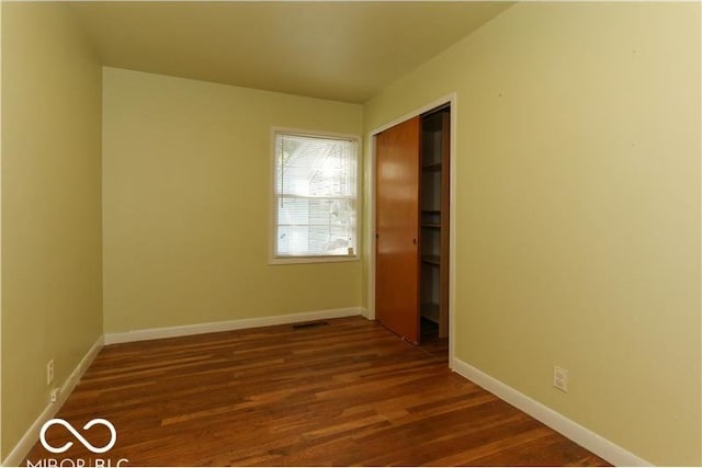 unfurnished room featuring dark hardwood / wood-style floors