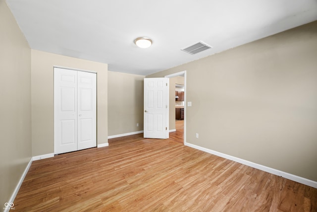 3233 Plum Creek Rd, Nashville, IN 47448 - unfurnished bedroom featuring baseboards, a closet, light wood finished floors, and visible vents