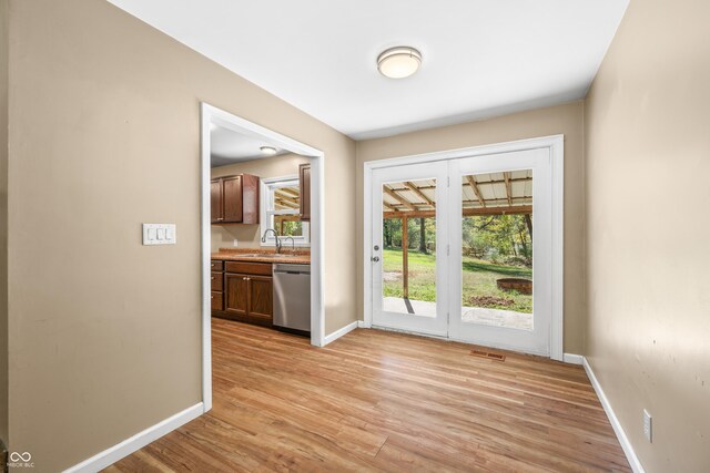 3233 Plum Creek Rd, Nashville, IN 47448 - entryway with baseboards, a sink, a healthy amount of sunlight, and light wood-type flooring