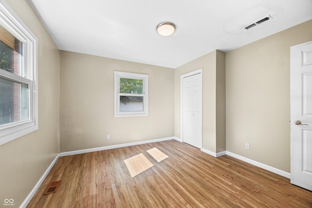 3233 Plum Creek Rd, Nashville, IN 47448 - unfurnished bedroom with visible vents, light wood-style flooring, and baseboards