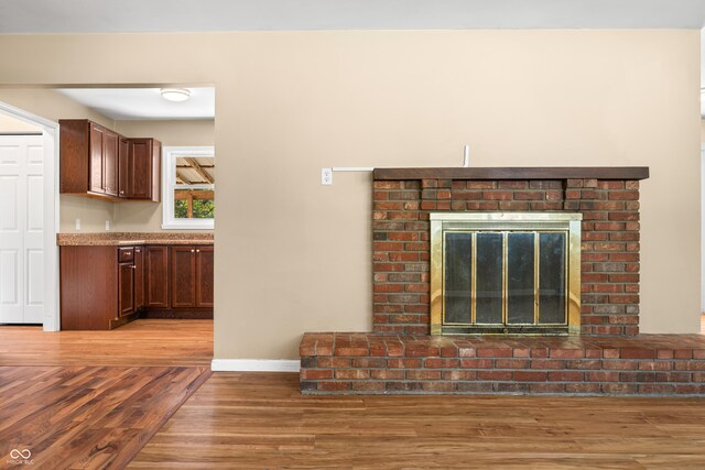 3233 Plum Creek Rd, Nashville, IN 47448 - room details with baseboards, wood finished floors, and a fireplace