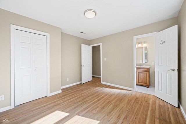 3233 Plum Creek Rd, Nashville, IN 47448 - unfurnished bedroom with light wood-style floors, baseboards, a closet, and connected bathroom