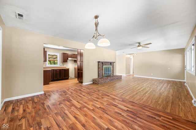3233 Plum Creek Rd, Nashville, IN 47448 - unfurnished living room with ceiling fan, a healthy amount of sunlight, baseboards, and light wood-type flooring