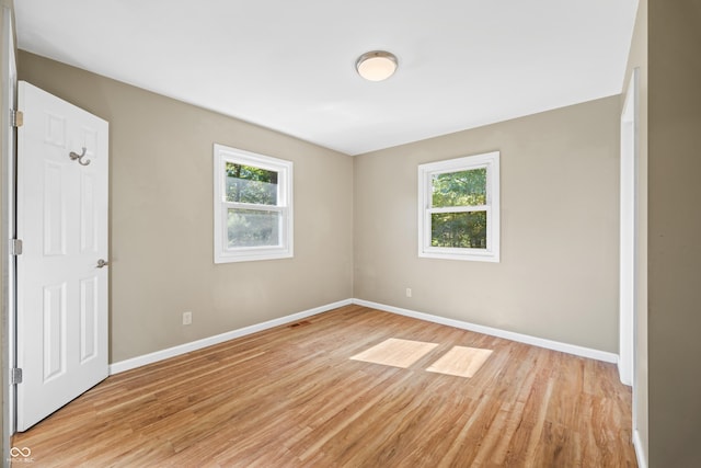 3233 Plum Creek Rd, Nashville, IN 47448 - unfurnished room with baseboards, visible vents, a healthy amount of sunlight, and light wood finished floors