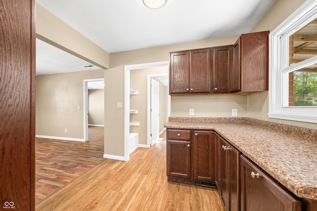 3233 Plum Creek Rd, Nashville, IN 47448 - kitchen featuring light countertops, dark brown cabinets, baseboards, and light wood-type flooring