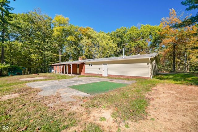 3233 Plum Creek Rd, Nashville, IN 47448 - rear view of house featuring a lawn, a chimney, and a patio area